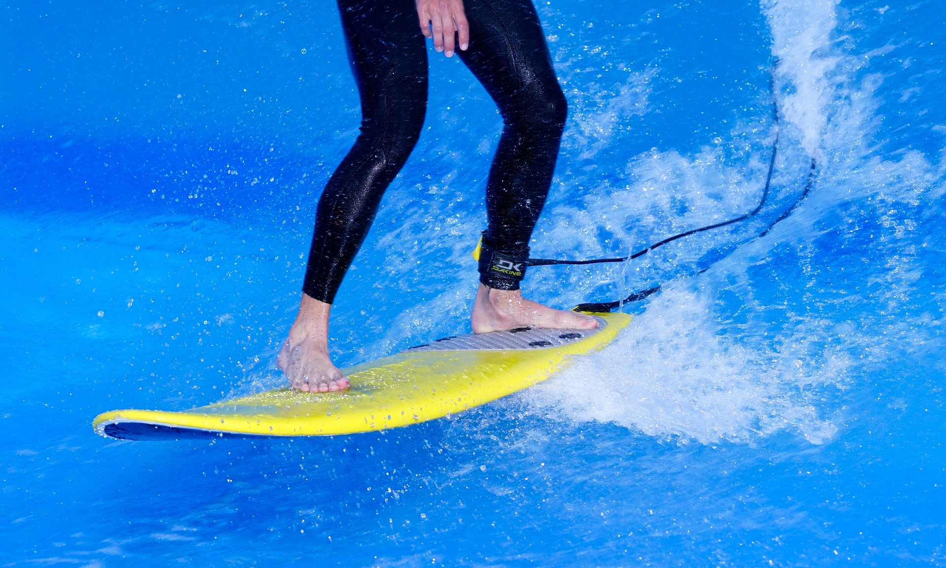 Surfer using balance to stand on his surfboard.