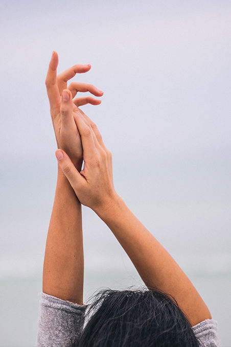 Woman has her hands in the air which helps her feel free