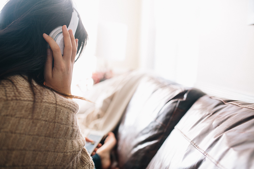 Girl listening to music on the couch
